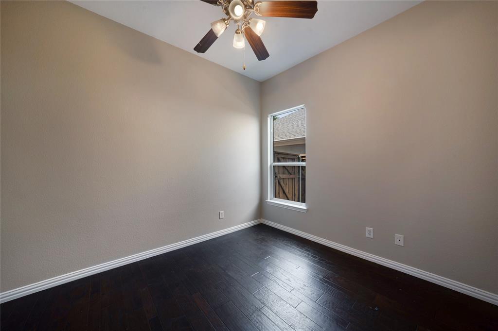 3418 Oakleigh Lane Frisco, TX 75033 - Photo 33 of 37 an empty room with wooden floor chandelier fan and windows