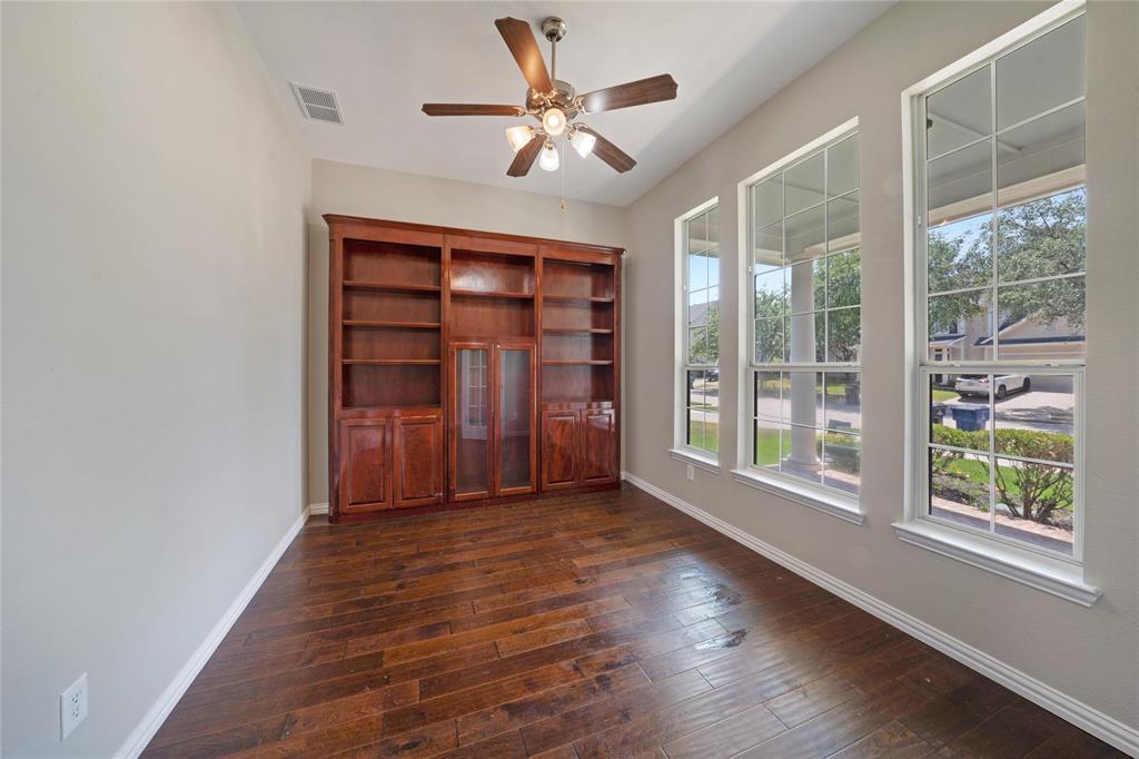 3418 Oakleigh Lane Frisco, TX 75033 - Photo 5 of 37 a view of an empty room with a window and wooden floor