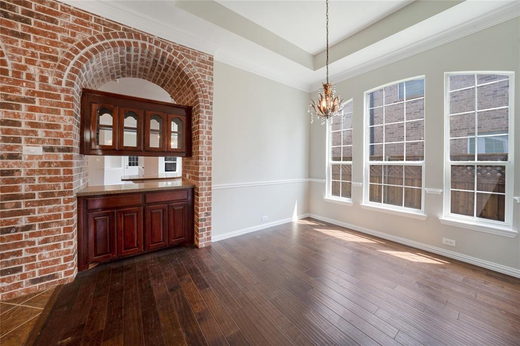 3418 Oakleigh Lane Frisco, TX 75033 - Photo 7 of 37 a view of an empty room with a kitchen and wooden floor