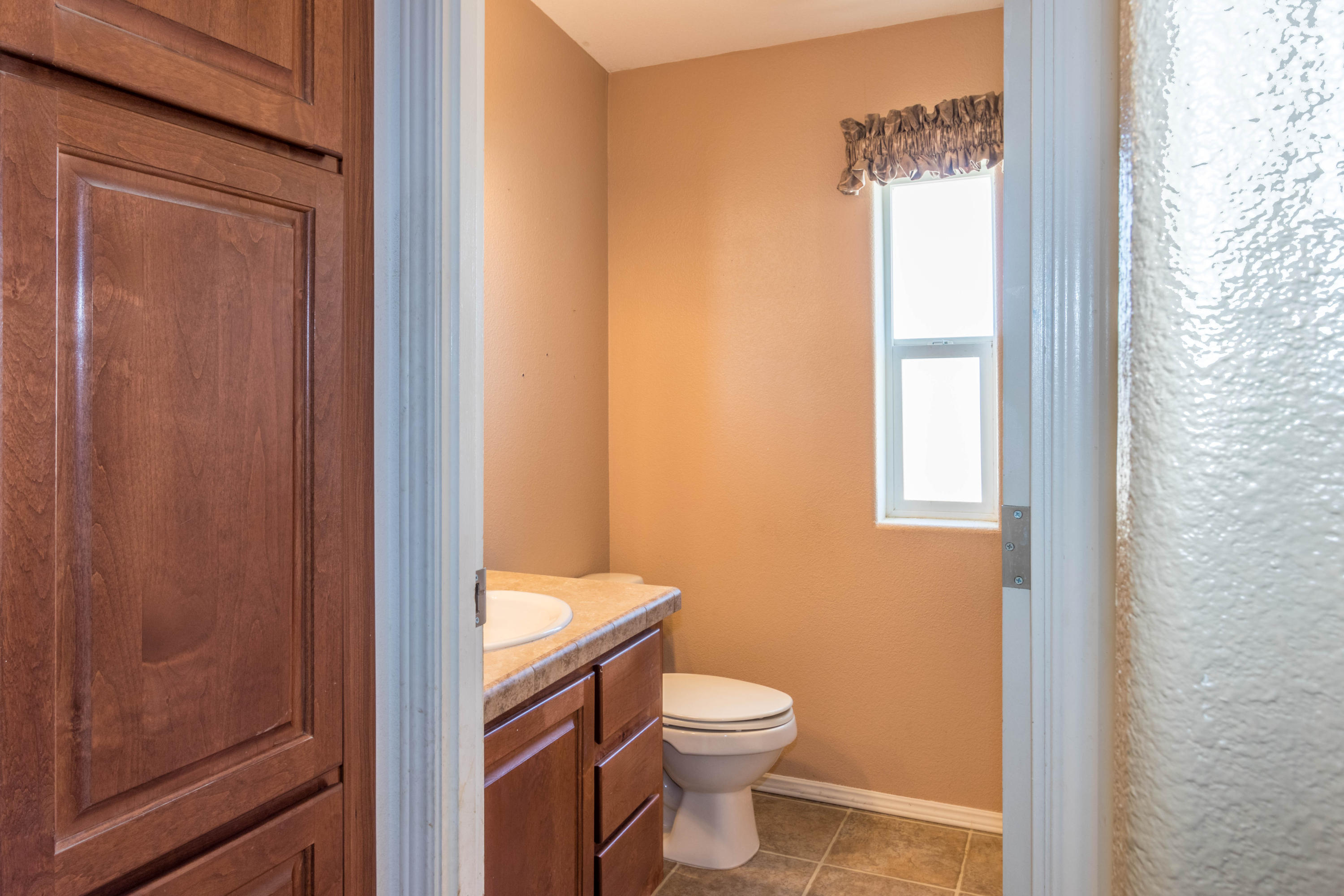4403 Backus Road Mojave, CA 93501 - Photo 12 of 35 a bathroom with a toilet a sink and a window