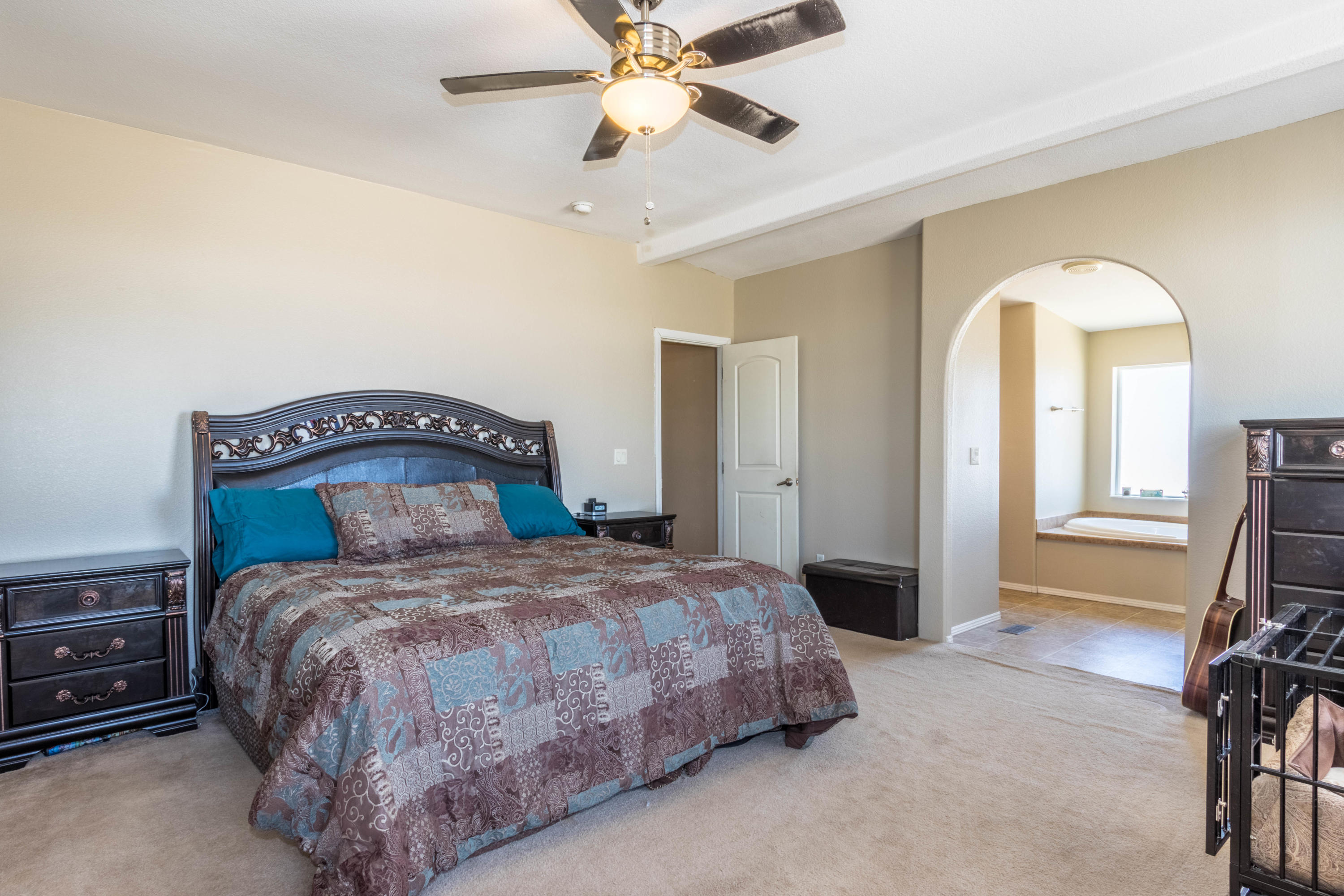 4403 Backus Road Mojave, CA 93501 - Photo 13 of 35 a bedroom with a bed and a chandelier