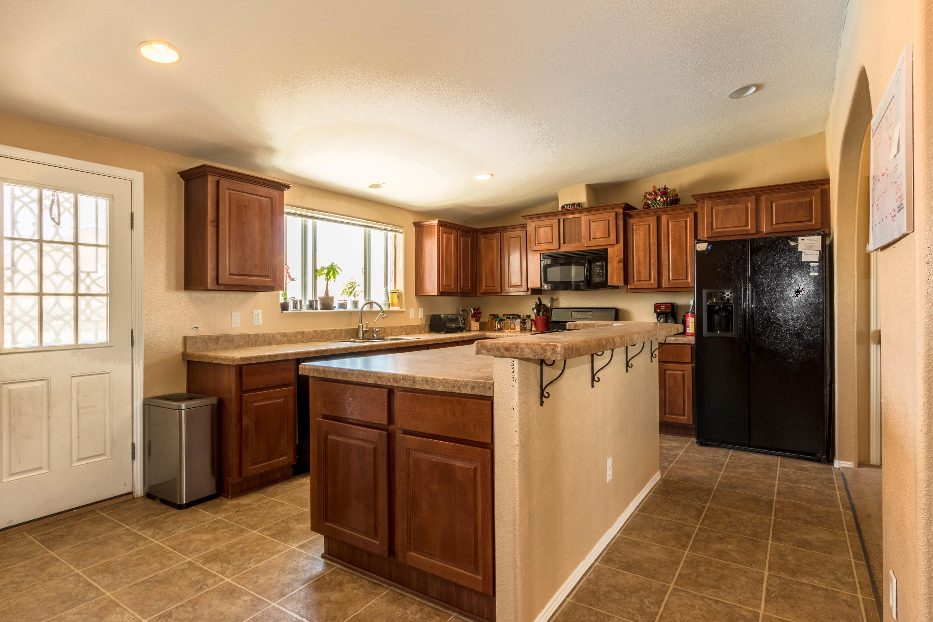 4403 Backus Road Mojave, CA 93501 - Photo 6 of 35 a kitchen with a refrigerator sink and cabinets