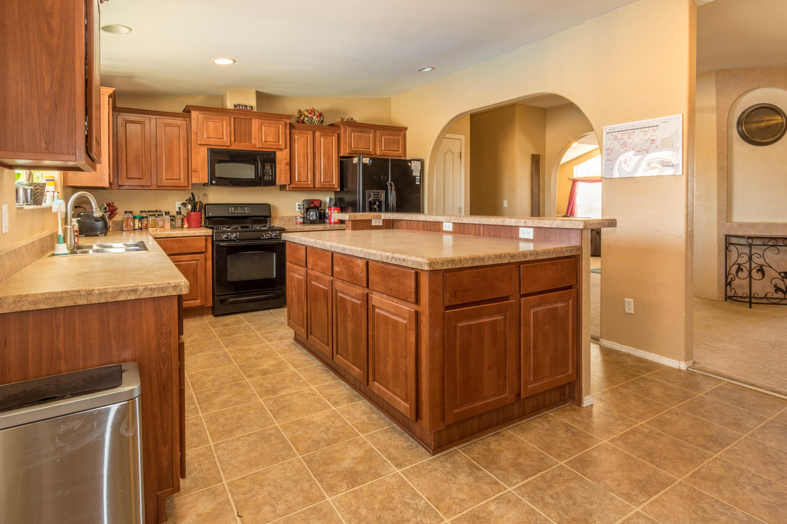 4403 Backus Road Mojave, CA 93501 - Photo 7 of 35 a kitchen with kitchen island granite countertop a stove top oven a sink a counter top space and cabinets