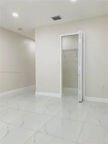 an empty room with white walls
