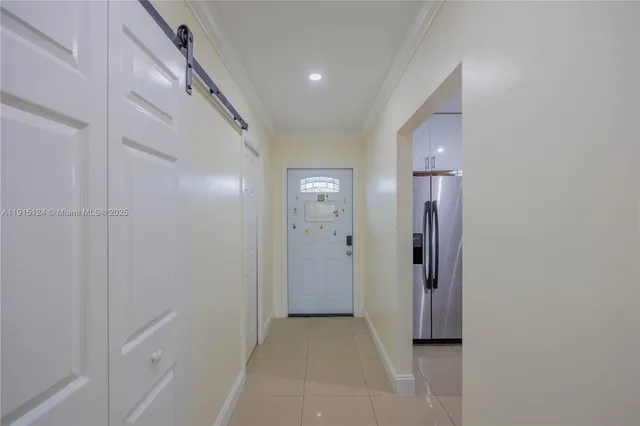 a view of a hallway with windows and closet