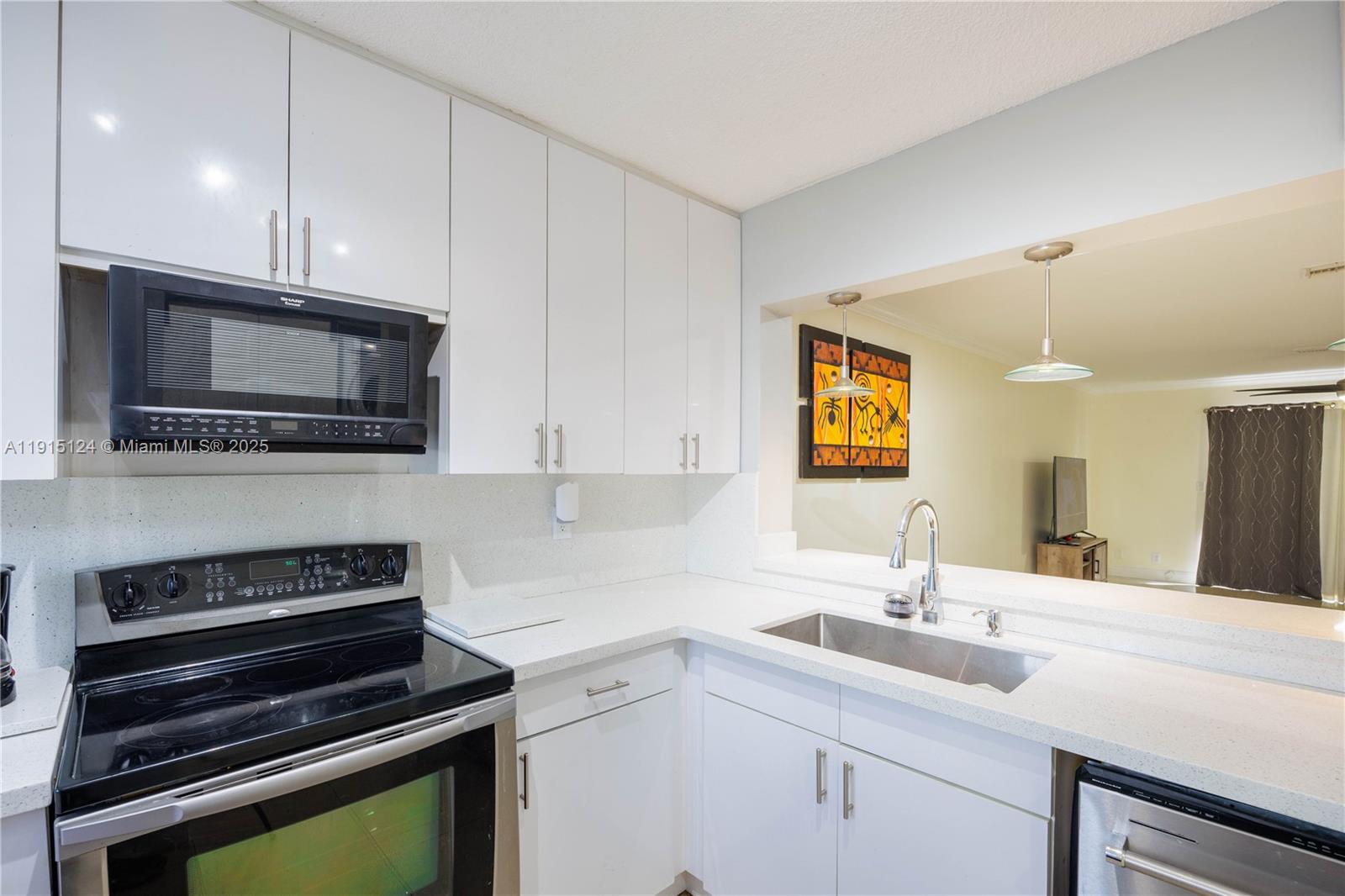 8325 Fairway Road Sunrise, FL 33351 - Photo 2 of 18 a kitchen with a sink and steel appliances