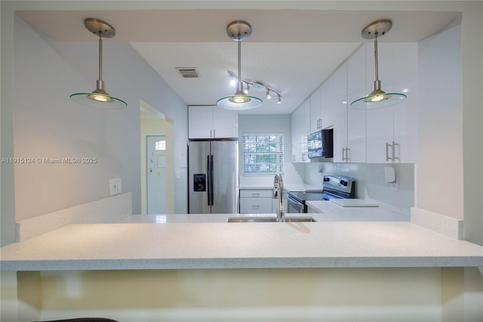 8325 Fairway Road Sunrise, FL 33351 - Photo 3 of 18 a view of a room with a chandelier furniture and windows