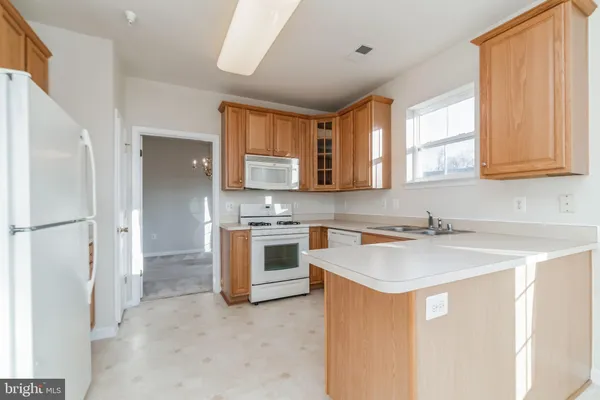 a kitchen with a sink stove and microwave