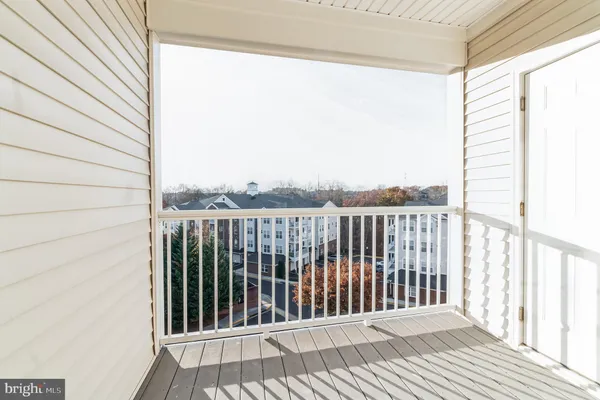 a view of a balcony with wooden floor