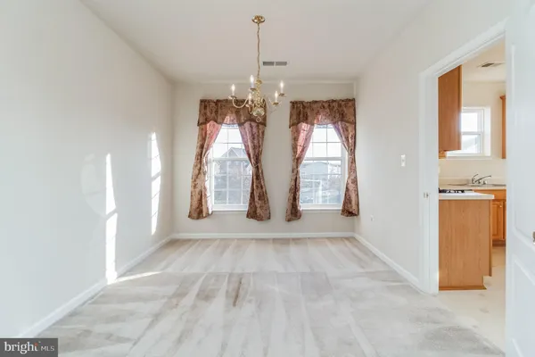 a view of entryway with chandelier and glass door
