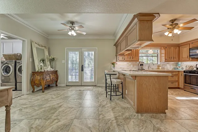 a living room with granite countertop furniture and a chandelier