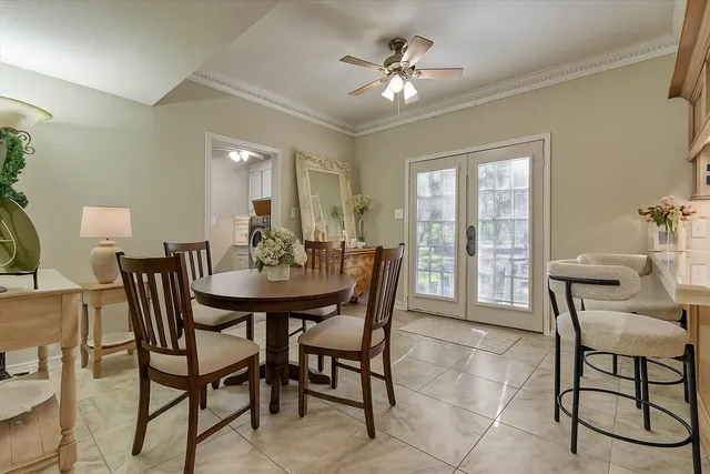 a view of a dining room with furniture and chandelier