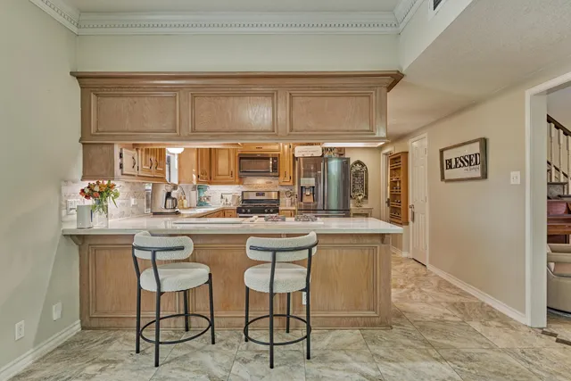 a kitchen with stainless steel appliances granite countertop a sink and cabinets