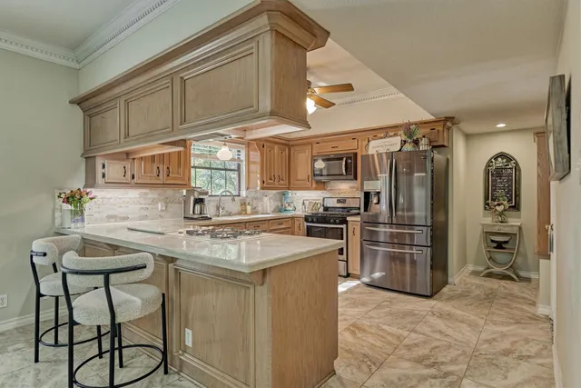 a kitchen with refrigerator and cabinets