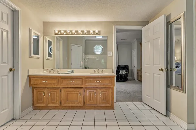 a bathroom with a shower sink and mirror