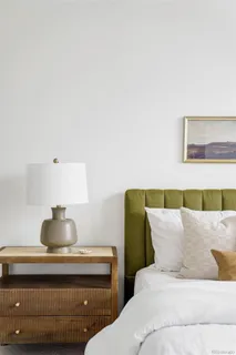 a living room with furniture and a lamp