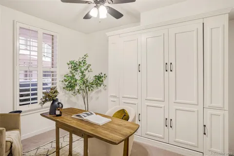 a view of a workspace with furniture and a potted plant