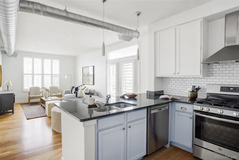 a kitchen with a sink stove a table and chairs