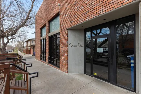 a backyard of a house with barbeque oven and outdoor seating