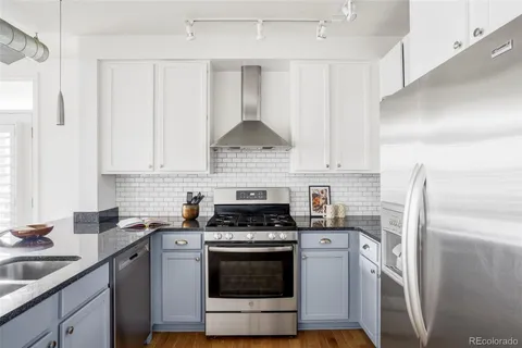 a kitchen with cabinets stainless steel appliances and a sink