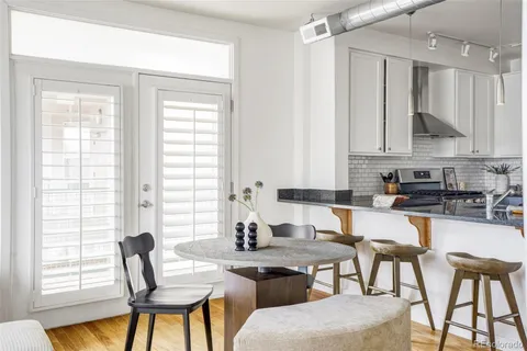 a kitchen with a table chairs stove and cabinets