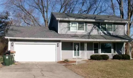 a front view of a house with garage