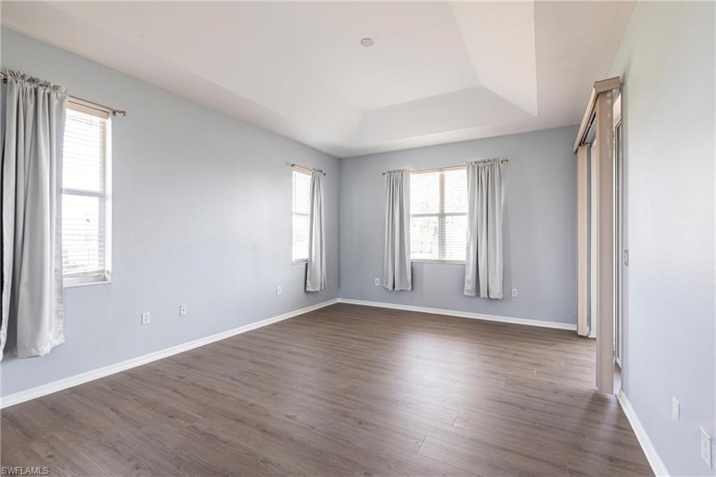 7306 Powder Puff Punta Gorda, FL 33955 - Photo 13 of 34 an empty room with wooden floor and windows