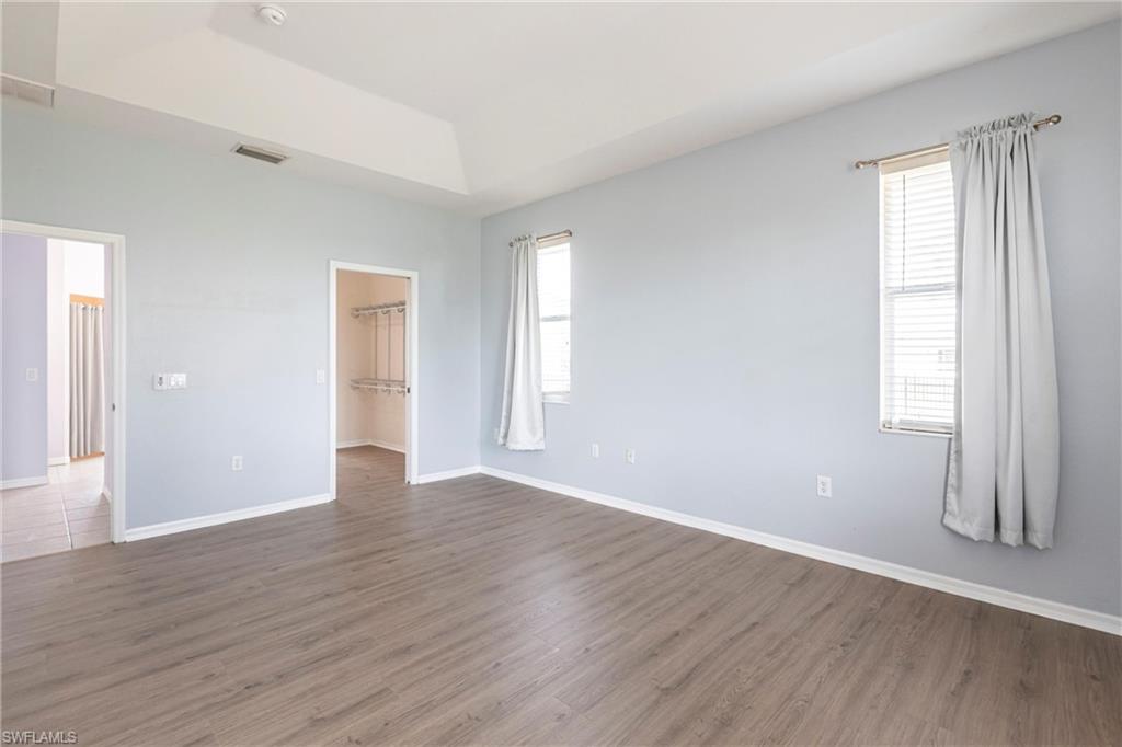 7306 Powder Puff Punta Gorda, FL 33955 - Photo 14 of 34 a view of an empty room with wooden floor and window