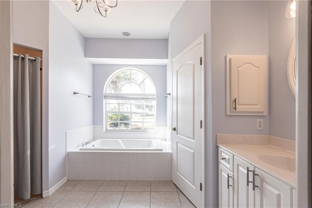 7306 Powder Puff Punta Gorda, FL 33955 - Photo 19 of 34 a spacious bathroom with a tub sink and mirror