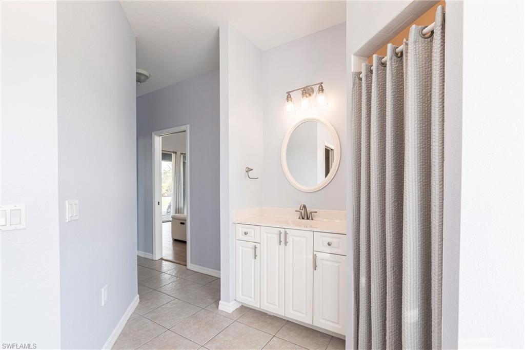 7306 Powder Puff Punta Gorda, FL 33955 - Photo 21 of 34 a bathroom with a granite countertop sink a mirror and a shower
