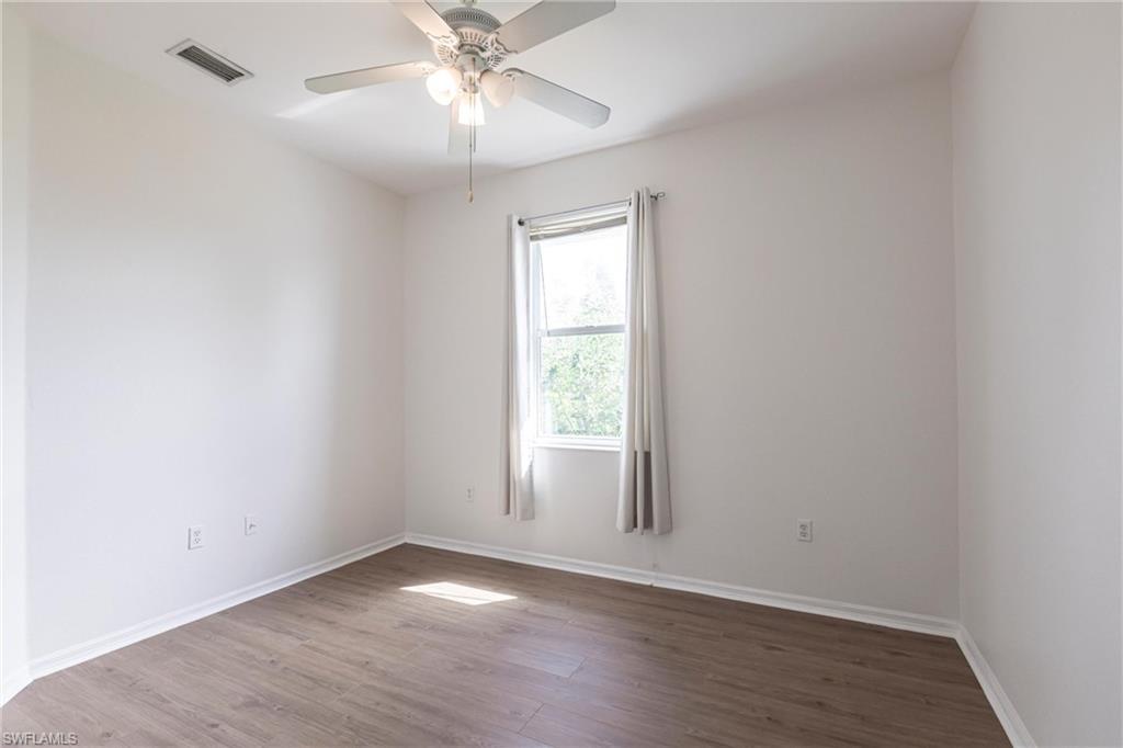 7306 Powder Puff Punta Gorda, FL 33955 - Photo 22 of 34 an empty room with wooden floor fan and windows