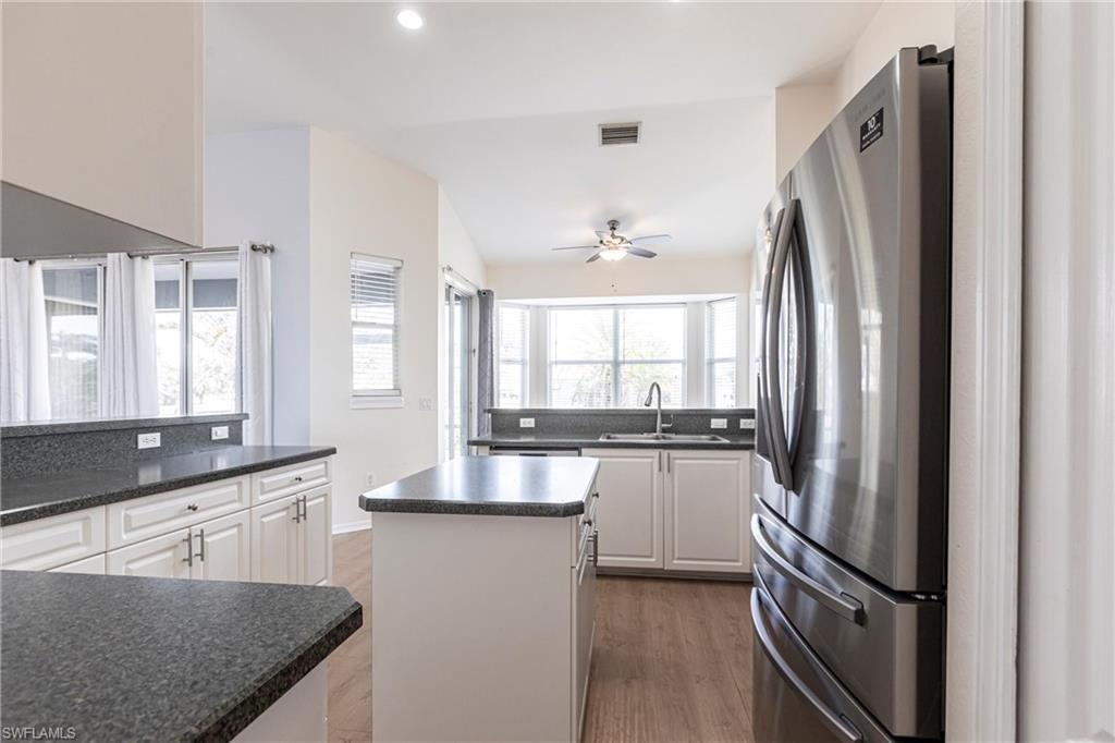7306 Powder Puff Punta Gorda, FL 33955 - Photo 6 of 34 a kitchen with stainless steel appliances granite countertop a refrigerator a sink and white cabinets