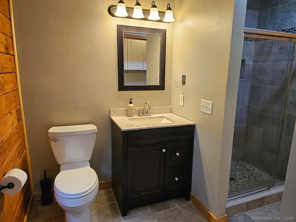 a bathroom with a toilet sink and a mirror