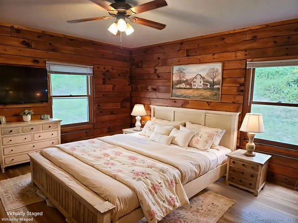 a bedroom with a bed and a flat screen tv