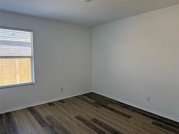 a room with wooden floor and window