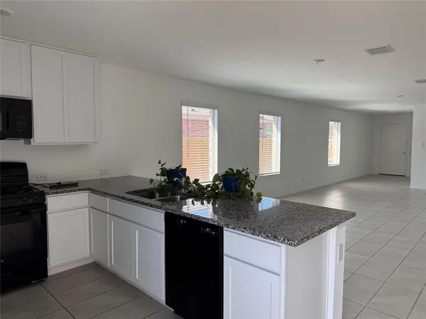 a kitchen with sink and cabinets