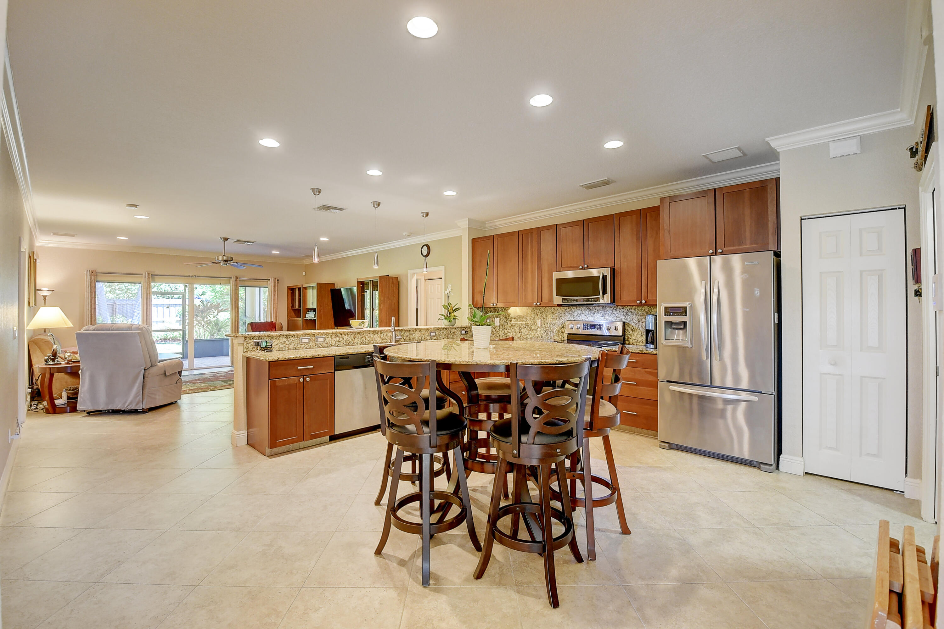215 Gulfstream Boulevard Boynton Beach, FL 33435 - Photo 13 of 39 a kitchen with stainless steel appliances kitchen island granite countertop a refrigerator and cabinets