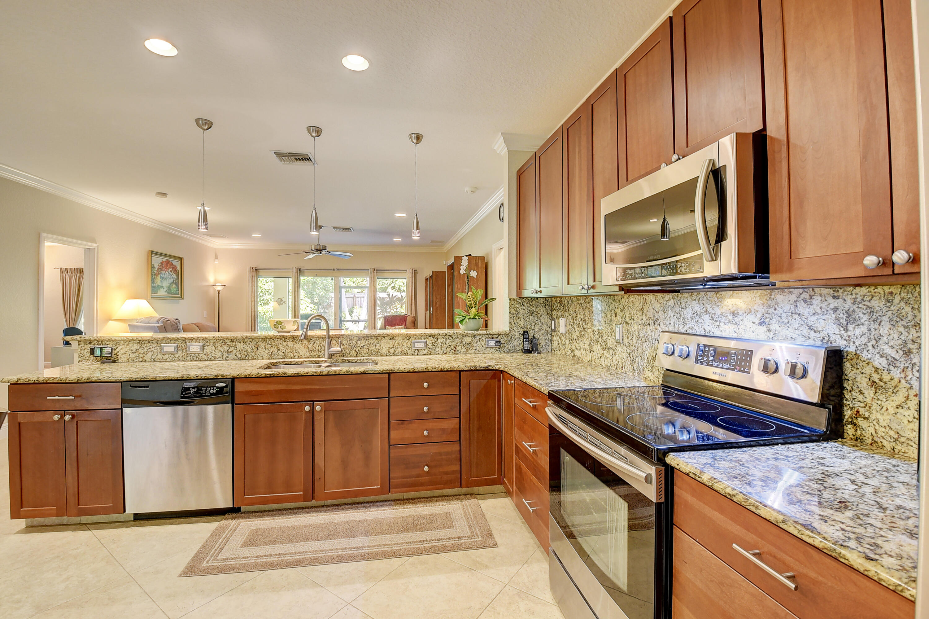 215 Gulfstream Boulevard Boynton Beach, FL 33435 - Photo 14 of 39 a kitchen with stainless steel appliances granite countertop a sink and stove top oven