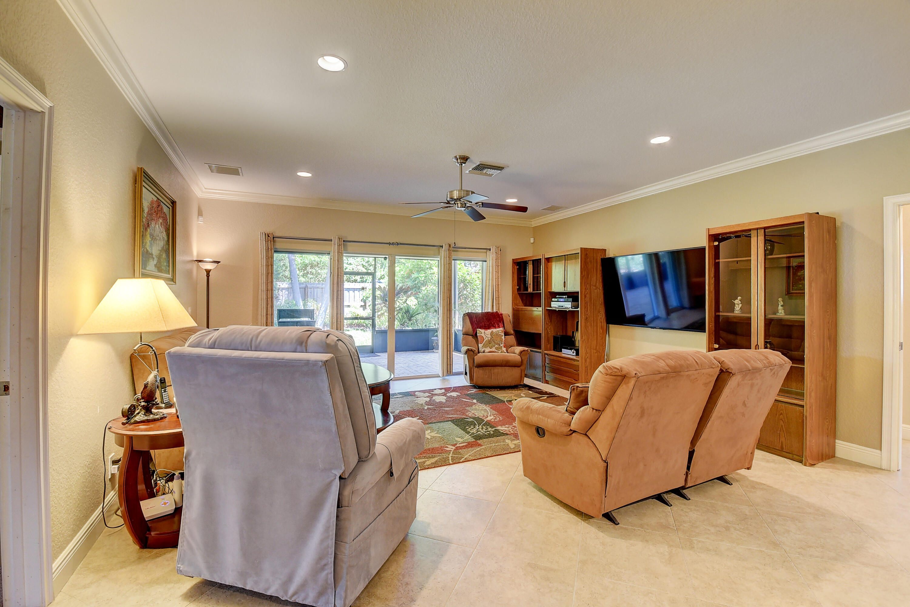 215 Gulfstream Boulevard Boynton Beach, FL 33435 - Photo 19 of 39 a living room with furniture and a chandelier