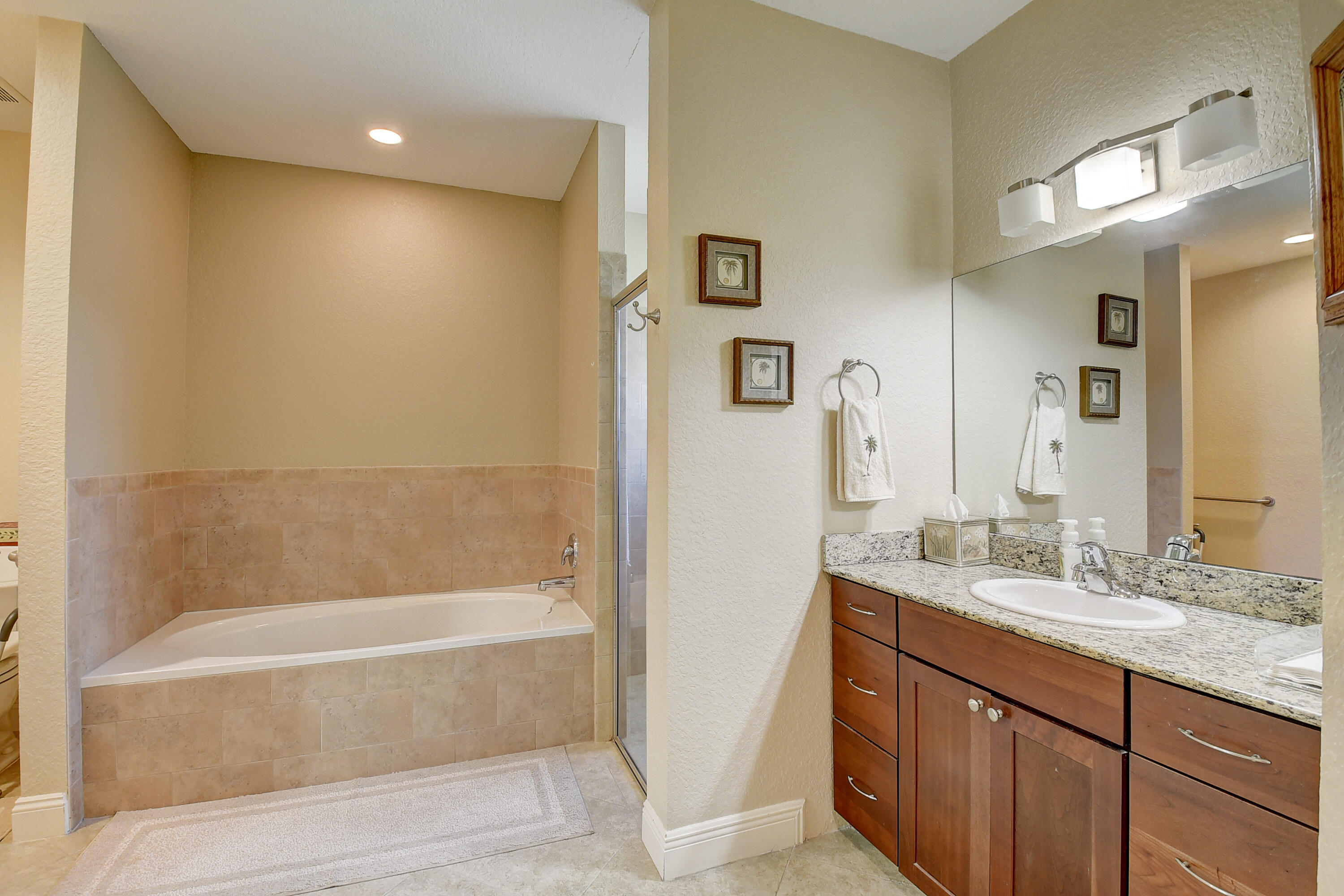 215 Gulfstream Boulevard Boynton Beach, FL 33435 - Photo 24 of 39 a bathroom with a granite countertop bathtub shower sink and mirror