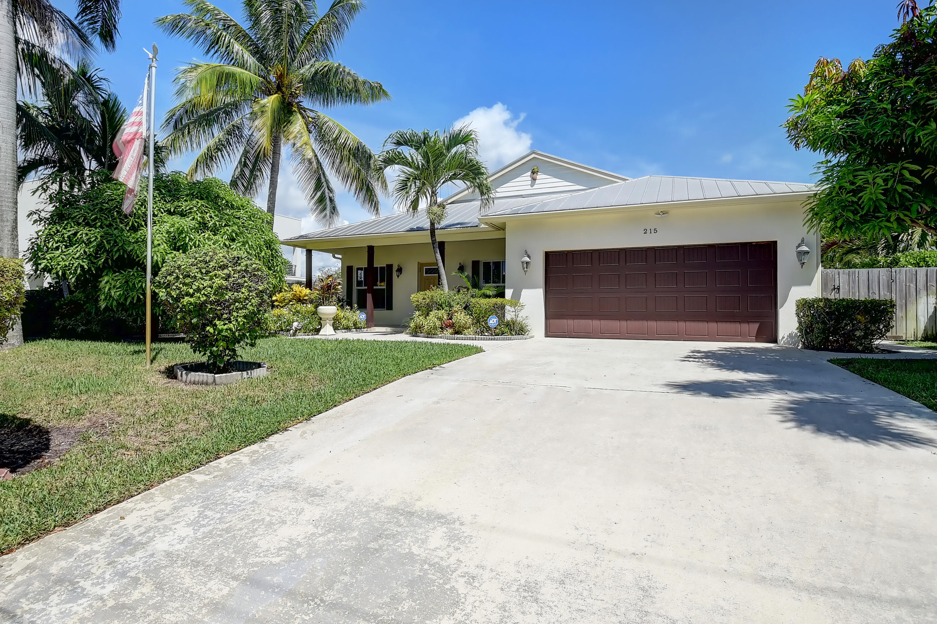 215 Gulfstream Boulevard Boynton Beach, FL 33435 - Photo 3 of 39 a front view of a house with a yard and a garage