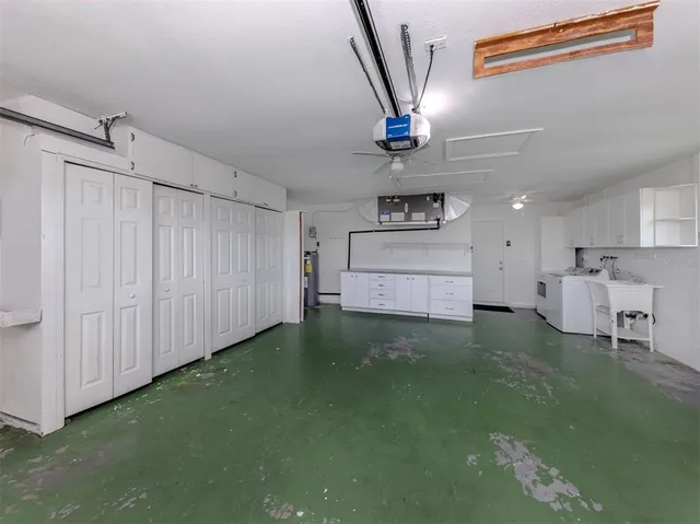 a kitchen with kitchen island a stove a chimney and a sink