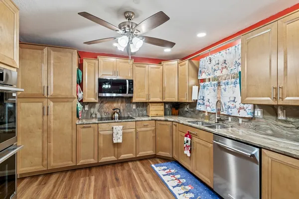 a kitchen with stainless steel appliances a refrigerator stove and microwave