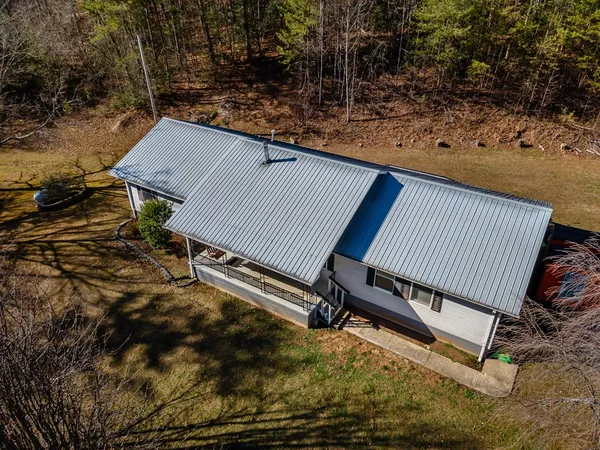 a house view with swimming pool and porch