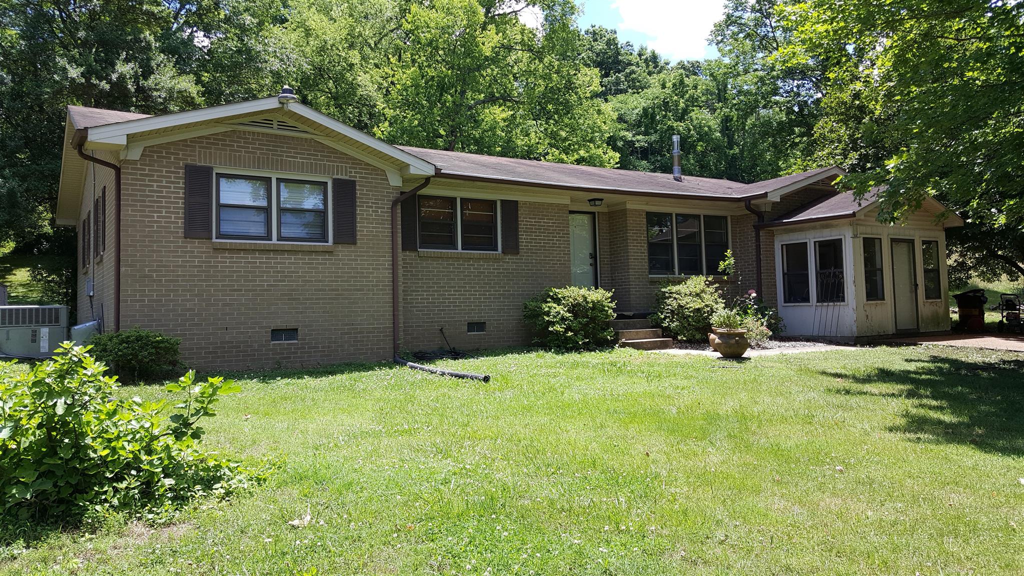 1232 Cliff Amos Road Spring Hill, TN 37174 - Photo 4 of 23 a front view of a house with a yard