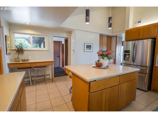 a kitchen with stainless steel appliances kitchen island granite countertop a sink and cabinets