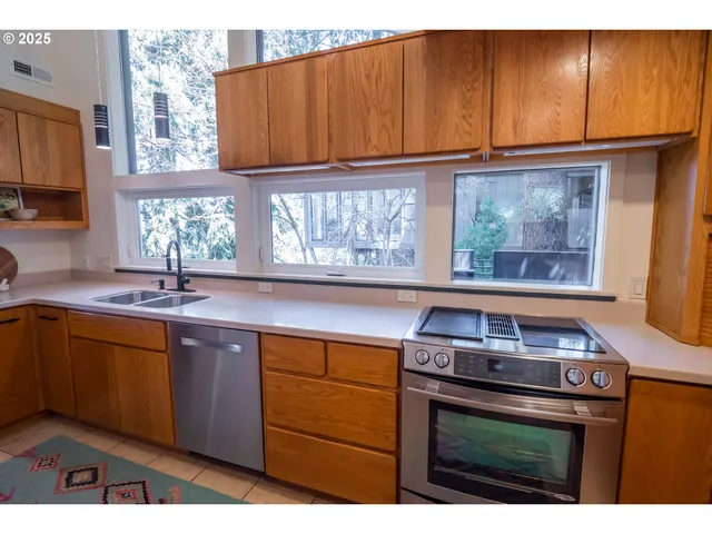 a kitchen with stainless steel appliances a refrigerator and a sink