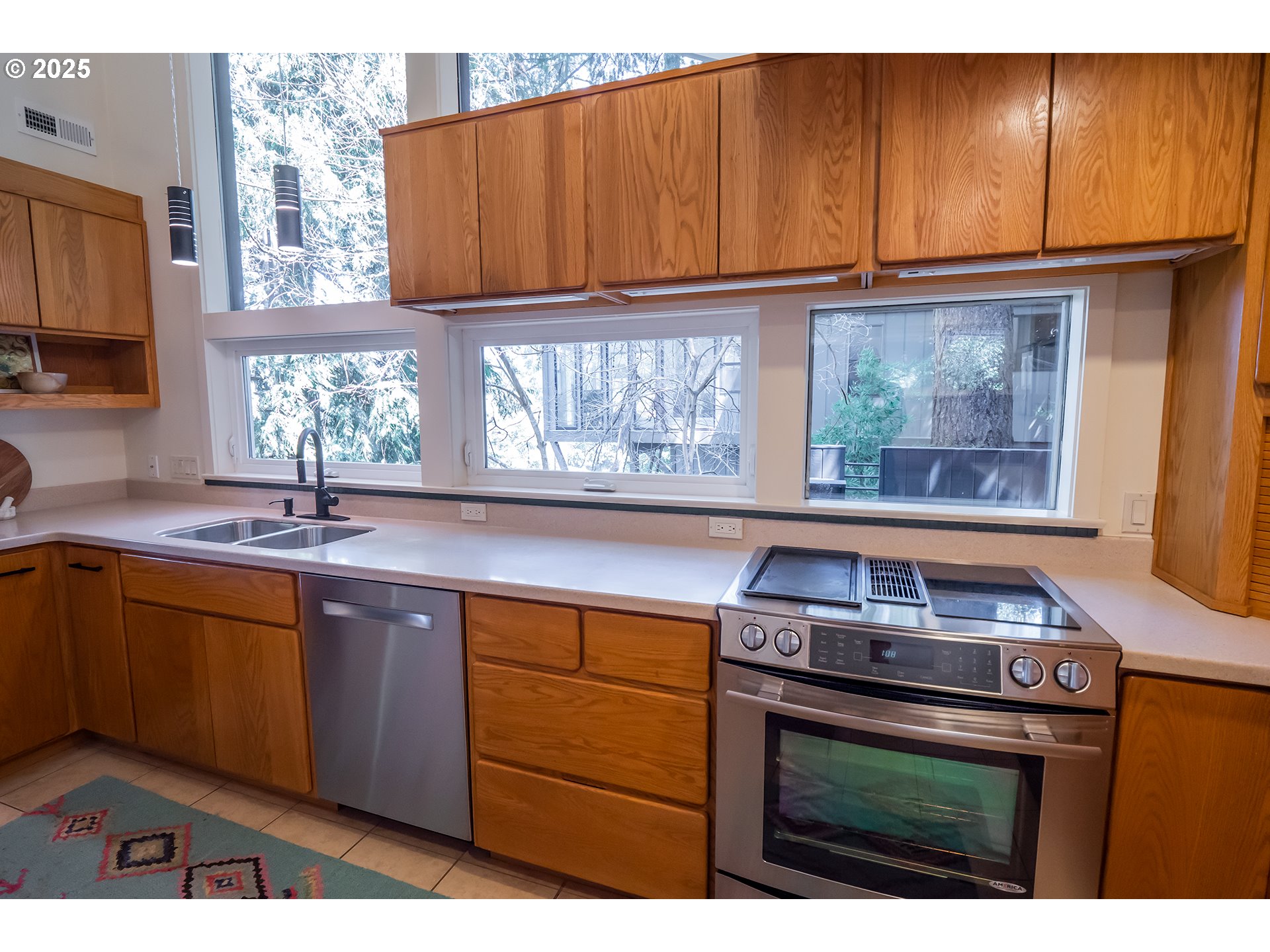 275 Sunset Drive Eugene, OR 97403 - Photo 14 of 45 a kitchen with granite countertop a stove a sink and a microwave