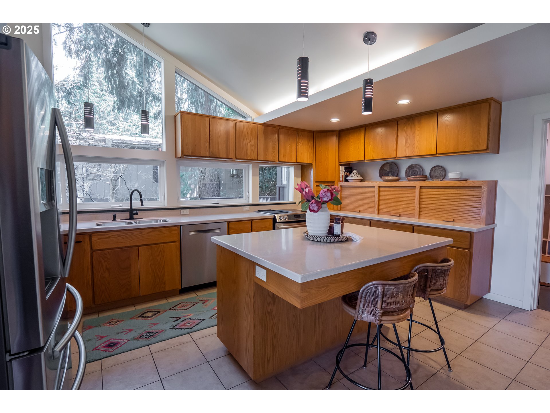 275 Sunset Drive Eugene, OR 97403 - Photo 16 of 45 a kitchen with stainless steel appliances a sink a counter top space cabinets and a window