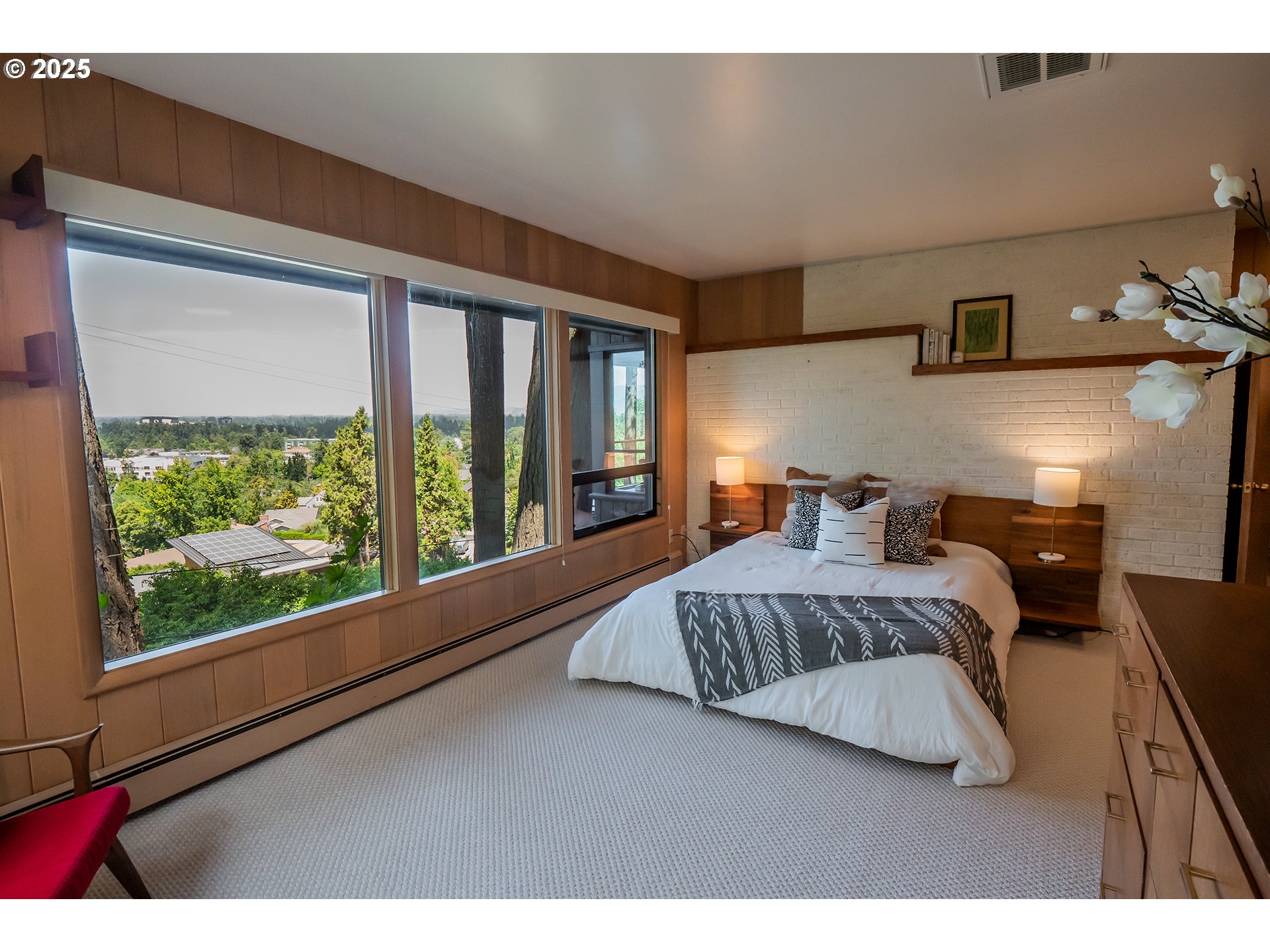 275 Sunset Drive Eugene, OR 97403 - Photo 17 of 45 a bedroom with a large bed and a large window